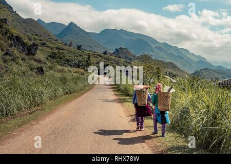 Tp. 9 Nov, 2018. Hà Giang, Vietnam - Due donna della minoranza Hmong a piedi attraverso le montagne con ceste sulle loro spalle. Credito: Daniel Dohlus/ZUMA filo/Alamy Live News Foto Stock