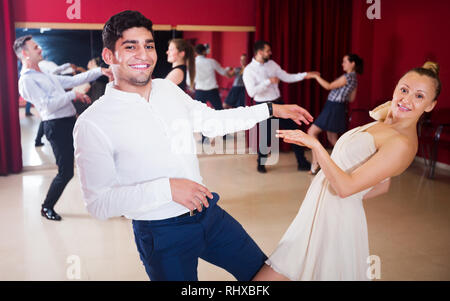 Ritratto di adulti coppie danzanti godendo di danza attivo in studio moderno Foto Stock