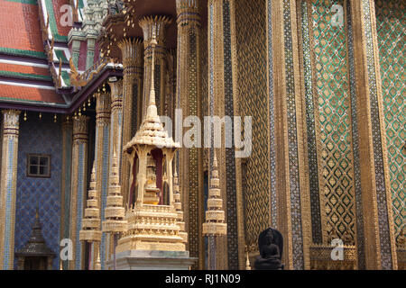 Ornato dettagli degli esterni di Wat Phra Kaew tempio con colonne e statue entro il Grand Palace complesso a Bangkok, in Thailandia Foto Stock