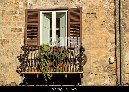 Finestra tradizionale e balcone con persiane di legno della vecchia casa in Palermo. Sicilia, Italia Foto Stock