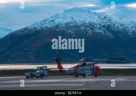 Una guardia costiera di matasse di aviatore una stazione aria Kodiak MH-60 elicottero Jayhawk sulla stazione di aria la pista di Kodiak, Alaska, Gennaio 30, 2019. Alcune di aria della stazione comprendono missioni di ricerca e salvataggio, l'applicazione della legge e la protezione delle risorse marine viventi. Stati Uniti Coast Guard foto di Sottufficiali di prima classe Ashley Wallace. Foto Stock