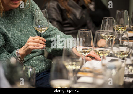 Persone degustazione di vino bianco durante una masterclass. Foto Stock