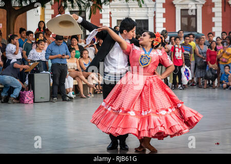 La folla guarda la sua fama Marinera danza di Trujillo, Perú, in stile coloniale e la piazza principale della città. Foto Stock