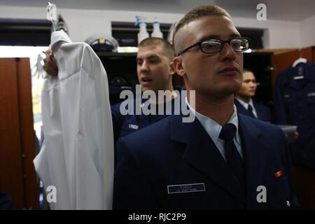 Stati Uniti Coast Guard Petty Officer di 2a classe di Michael Lynch, un trainer per gli Stati Uniti il cerimoniale Guardia d'onore, ispeziona le uniformi di U.S. Coast Guard marinaio Jagger Kaber, un non-rate con l'USCG-CHG nov. 2, 2016 presso la Guardia d'onore caserma della Guardia Costiera di telecomunicazione e sistemi di informazione della stazione di comando ad Alessandria, Va. Il Coast Guard cerimoniale di guardia d'onore rappresenta il comandante della USCG, Distretto Militare di Washington e la United States Coast Guard attraverso operazioni di cerimoniale detenute prima i leader del mondo e dignitari. Essi sono pianificati per partecipare Foto Stock