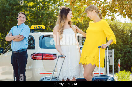 Migliori amici uscendo di taxi dal viaggio di shopping in città Foto Stock