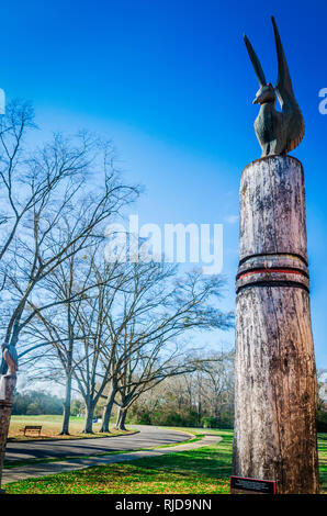 Totem sormontato da Legno complessamente intarsiato di volatili sentinella stand nella parte anteriore del Jones museo archeologico in Moundville, Alabama. Foto Stock