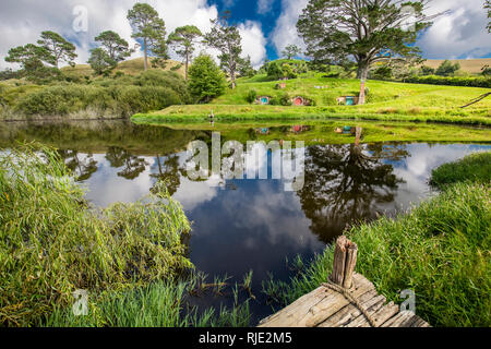 MataMata, Nuova Zelanda - Marzo 2017 Hobbit mirroring casa in riva al lago Foto Stock