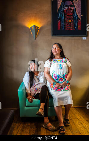 Due dei nativi americani donne Pueblo di Taos Pueblo in posa per un ritratto all'interno di un adobe house, Nuovo Messico, Stati Uniti d'America, America del Nord Foto Stock