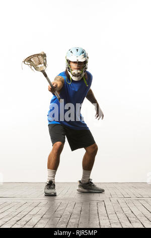 L'uomo la modellazione di lacrosse Casco e stick Foto Stock