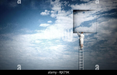 Imprenditrice permanente sulla scaletta e salendo fino alla finestra. I supporti misti Foto Stock