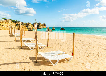 Riga vuota di lettini per prendere il sole sulla spiaggia di sabbia, Alvor, Algarve, Portogallo, Europa Foto Stock