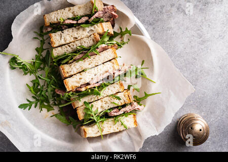 Immagine di overhead di arrosto di manzo con sandwich rugula e senape Foto Stock