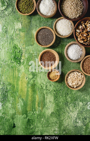 Varietà di materie non cotti i grani di cereale super chia biancheria, sesamo, Mung bean, noci, tapioca, frumento, grano saraceno, fiocchi d'avena, noce di cocco, riso in legno da bo Foto Stock