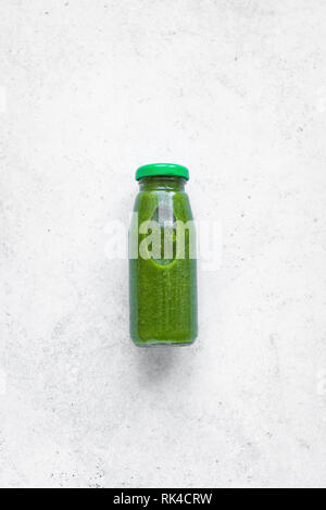 Frullato verde bottiglia su sfondo bianco, vista dall'alto. Detox, pulire mangiare, dieta e mangiare sano concetto, copia dello spazio. Foto Stock