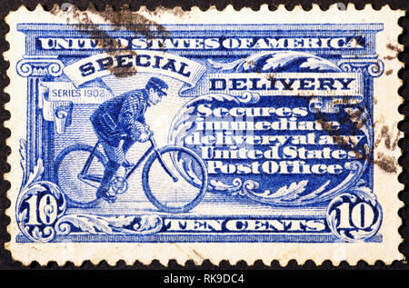Portalettere ciclismo su molto vecchio american francobollo Foto Stock