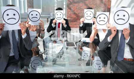 La gente di affari con un poster con una faccia dipinta su di esso invece di una persona, il concetto di falsità in business Foto Stock