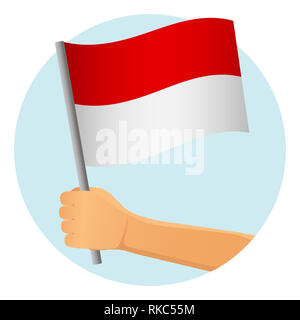Bandiera dell'Indonesia in mano. Sfondo patriottico. Bandiera nazionale di Indonesia illustrazione Foto Stock