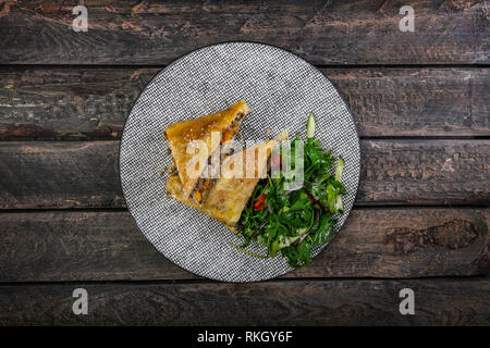 Strudel di cavolo stufati, Carne e insalata servita sulla piastra ceramica. Foto Stock