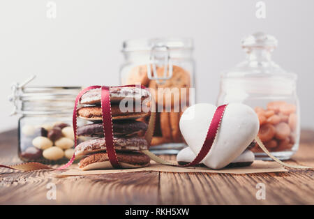 Gingerbread cookies, caramelle, dolci, caramelle in vasi su un tavolo di legno Foto Stock