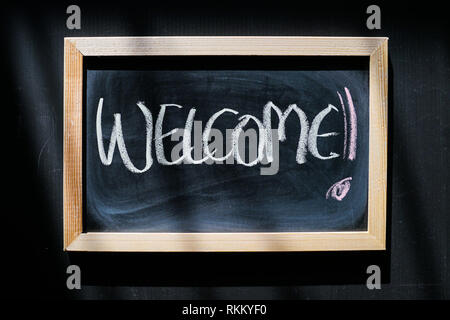 Benvenuti - parole scritte a mano con un gessetto sulla lavagna Foto Stock