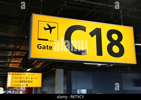 Aeroporto di generico di segnaletica in Amsterdam. Cancelli illuminato segno. Foto Stock