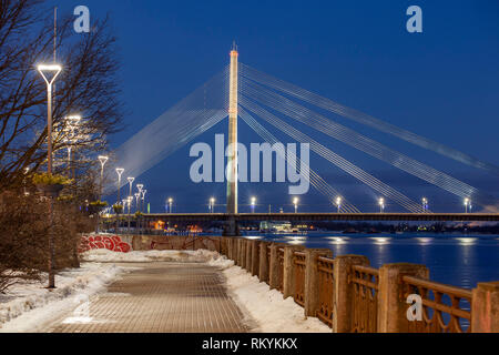 Notte invernale a ponte Vansu attraverso fiume Daugava a Riga. Foto Stock