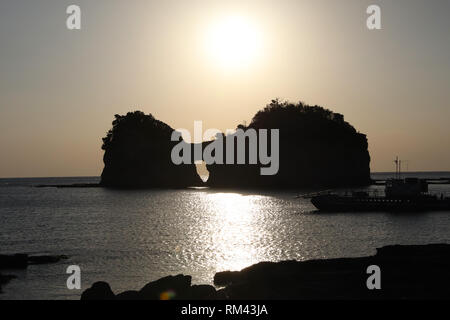 Wakayama. Xiii Febbraio, 2019. Foto scattata il 13 febbraio, 2019 mostra Engetsu isola sotto il tramonto in Wakayama, Giappone. Engetsu Island è una piccola isola con un arco naturale al largo della costa di Shirahama in Giappone della prefettura di Wakayama. Credito: Du Natalino/Xinhua/Alamy Live News Foto Stock