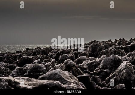 Rocce a picco sul mare in una luce lunare exposition Foto Stock