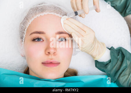 Donna cosmetico ricevente iniezione nel salone di bellezza Foto Stock