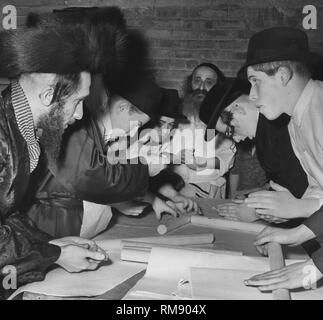 Hasidic ebrei in Chicago rendere matzo per la Pasqua ebraica, ca. 1966. Foto Stock