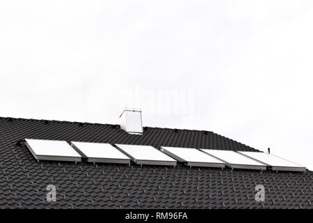 Acqua calda di pannelli solari sul tetto della casa Foto Stock