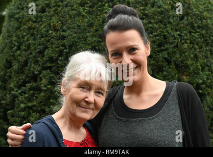 Holste, Germania. Xiii Febbraio, 2019. Gisela Ehlers (l) è abbracciato in giardino da sua figlia Anica. Durante il disastro di neve 40 anni fa, il 14.2.1979, ella ha dato nascita a Anica in un serbatoio. Tra il 13 e 18 febbraio 1979, gli allarmi di emergenza sono state suonava nel nord-ovest della Bassa Sassonia dopo intense nevicate con uragano-come i venti. Credito: Carmen Jaspersen/dpa/Alamy Live News Foto Stock