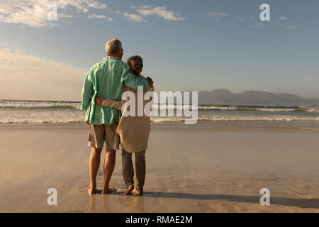 Coppia senior assieme braccio intorno sulla spiaggia Foto Stock