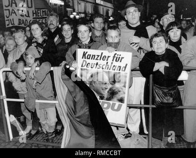 Adolescente "fan" tenere premuto un cartellone elettorale con una foto del Cancelliere Helmut Kohl e la scritta "Il Cancelliere per la Germania " a CDU campagna elettorale in occasione della campagna elettorale per il primo Bundestag tedesco elezioni.