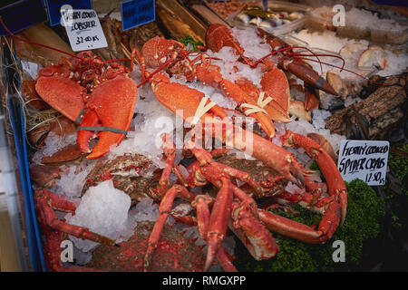 Crostacei tra cui aragoste e granchi in vendita presso un pescivendolo nei locali di un mercato alimentare. Formato orizzontale. Foto Stock