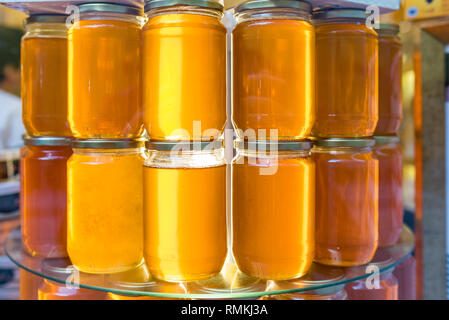 I vasetti con fatti in casa miele biologico.Vari barattoli di miele sono venduti in stallo. Foto Stock
