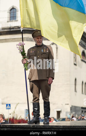 Lviv, Ucraina - 24 agosto 2017: un veterano dell'Ucraina esercito di insorti detiene una bandiera dell'Ucraina. Giorno di indipendenza dell'Ucraina Foto Stock