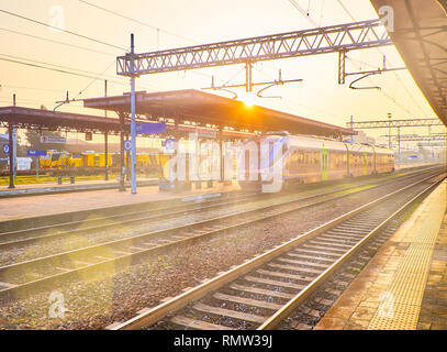 Asti, Italia - Gennaio 1, 2019. Un treno di Trenitalia in un italiano stazione ferroviaria al tramonto. Asti, Piemonte, Italia. Foto Stock