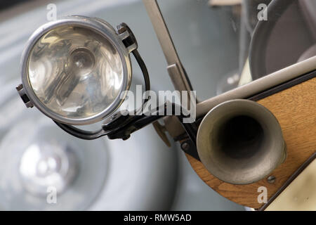 Il faro con avvisatore acustico sulla vecchia auto. Il veterano della vettura con il classico klaxon e riflettore, vicino. Foto Stock