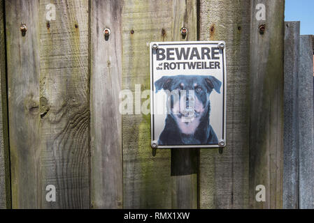 Una attenzione al cane segno avvitato ad una palizzata di recinzione di legno in un sobborgo di Sydney Foto Stock