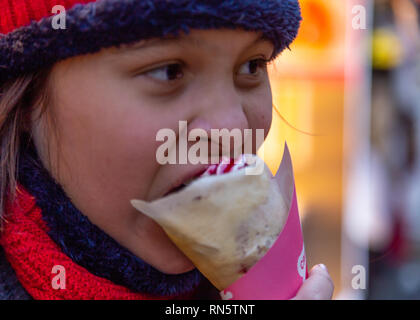 Asian American Girl eating crêpe Foto Stock