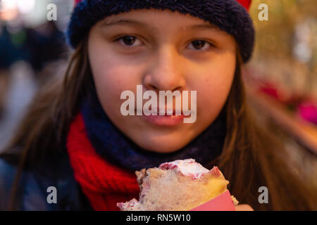 Asian American Girl eating crêpe Foto Stock