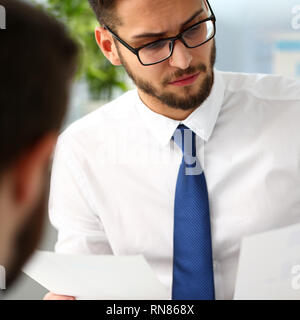 Un gruppo di imprenditori con grafico finanziario nel braccio di risolvere e discutere il problema Foto Stock