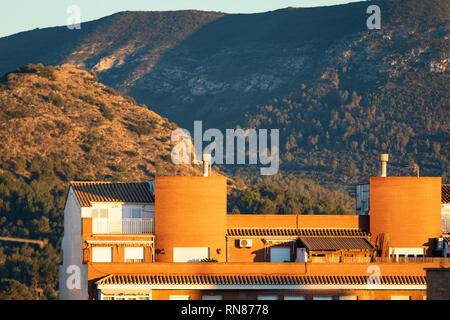 Apartament blocchi in Spagna durante il tramonto con le montagne sullo sfondo Foto Stock