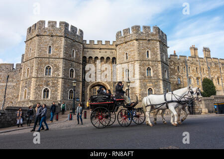 Un carro trainato da cavalli al di fuori del Castello di Windsor tirato da due cavalli bianchi è popolare con i turisti e offre passeggiate intorno a Windsor. Foto Stock