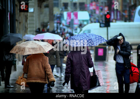 Glasgow, Scotland, Regno Unito 18th, febbraio 2019 UK Meteo: giornata piovosa come la gente del posto e i turisti godere dei loro ombrelloni.Credit Gerard Ferry/Alamy Live News Foto Stock