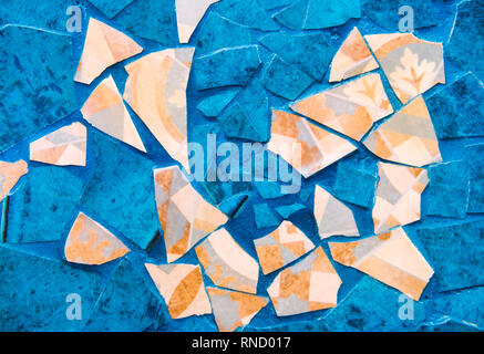 Sfondo originale, pezzi di piastrelle rotte, blu turchese e beige. Crepe, riproduzione del colore, antichità, vintage. Foto Stock