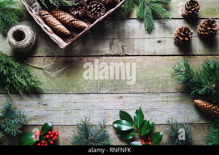 Decorazione di Natale utilizzando prodotti freschi e tutti i materiali naturali su un tavolo di legno. Foto Stock