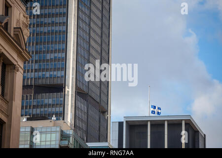 Bandiera del Quebec rinuncia nella vecchia Montreal, Quebec, Canada, circondato da moderni edifici per uffici e vecchi grattacieli. Noto anche come Fleur de Lys o fleu Foto Stock