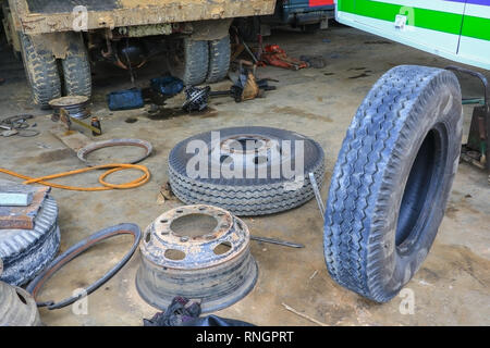 Bus di gomma della ruota in attesa di riparazione nel garage Foto Stock